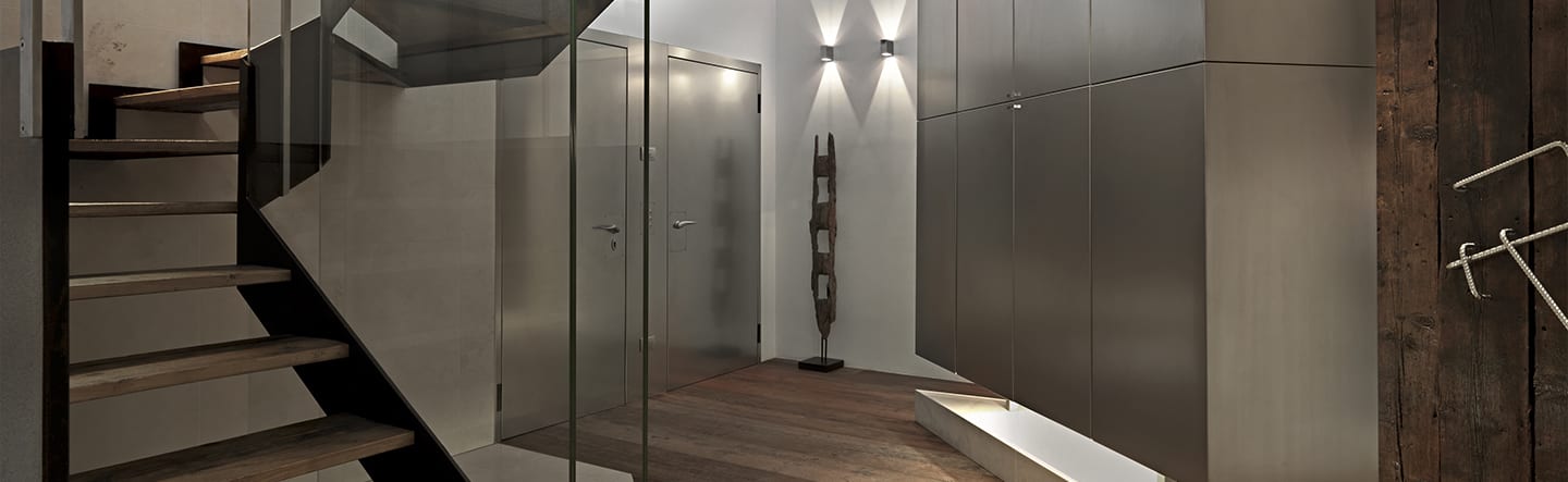 A luxury basement interior with a glass and timber staircase